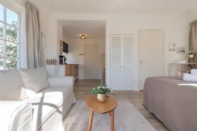 a living room with a couch and a table at Boutique Pension Bennekom - Studio's & Apartment in Zandvoort