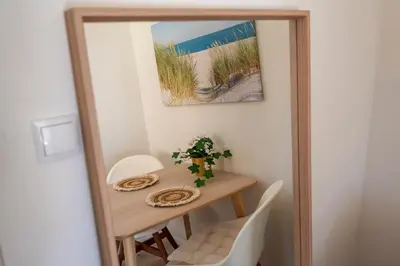 a table in a room with a mirror at Boutique Pension Bennekom - Studio's & Apartment in Zandvoort