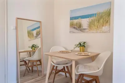 a dining room with a table and chairs and a mirror at Boutique Pension Bennekom - Studio's & Apartment in Zandvoort