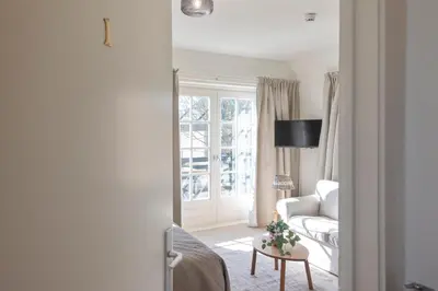 a living room with a couch and a table at Boutique Pension Bennekom - Studio's & Apartment in Zandvoort