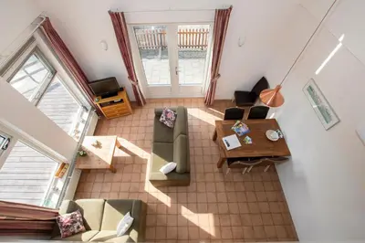 an overhead view of a living room with a couch and a table at Zaanse Rietveld Logies in Alphen aan den Rijn