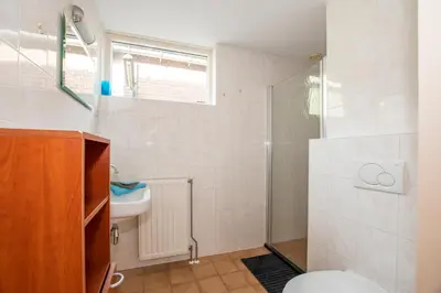 a bathroom with a shower and a toilet and a sink at Zaanse Rietveld Logies in Alphen aan den Rijn