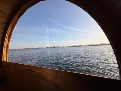 a window view of the water from a boat at Villa Perla Mare - Sauna Experience - On a lake near Amsterdam in Vinkeveen