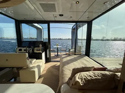 a boat with a bed and a couch on the deck at Villa Perla Mare - Sauna Experience - On a lake near Amsterdam in Vinkeveen