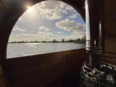 a boat with a window looking out over the water at Villa Perla Mare - Sauna Experience - On a lake near Amsterdam in Vinkeveen