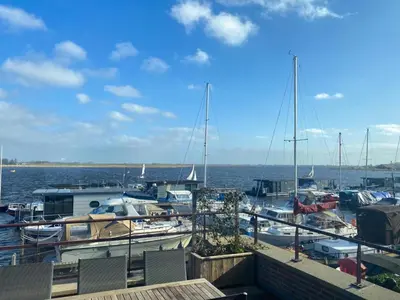 a group of boats docked at a marina on the water at Oostergeest in Uitgeest