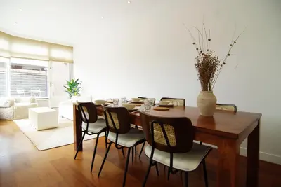 a dining room with a wooden table and chairs at spacious new appartment in Lisse