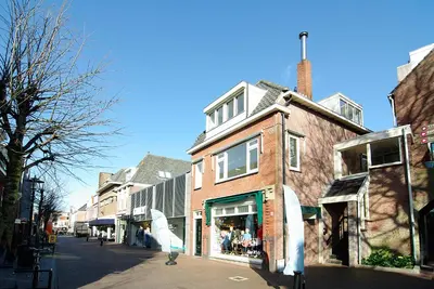 a brick building on the side of a street at spacious new appartment in Lisse