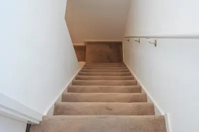 a stairway in a building with white walls at Garden House Harry in Zandvoort