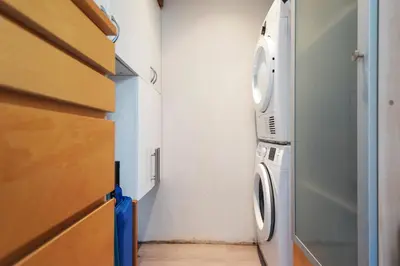 a laundry room with a washer and dryer at Garden House Harry in Zandvoort