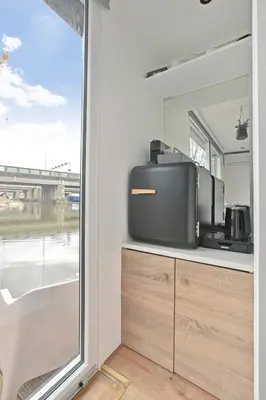 a tv sitting on a counter next to a window at HouseBoat the New Lake - Nieuwe Meer in Amsterdam