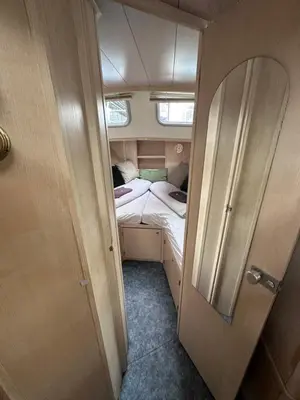 a small room with a bed in the middle at Luxury Houseboat in Amsterdam