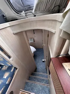 an empty room with stairs and a bed at Luxury Houseboat in Amsterdam