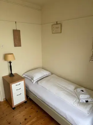 a small bedroom with a bed and a night stand at Blue Bay Zandvoort in Zandvoort