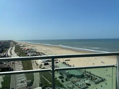 a view of a beach and the ocean at Blue Bay Zandvoort in Zandvoort