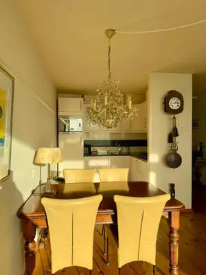 a dining room table with chairs and a chandelier at Blue Bay Zandvoort in Zandvoort