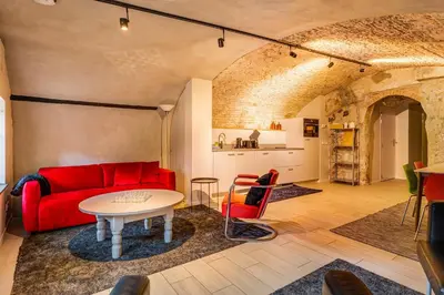 a living room with a red couch and a table at Beautiful canal apartment in Utrecht for 4 persons in Utrecht