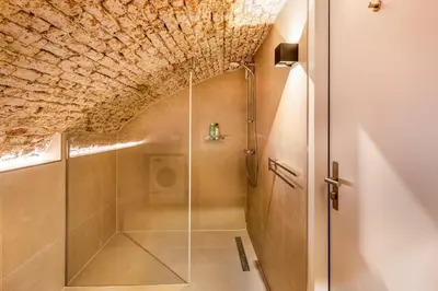 a bathroom with a shower with a glass door at Beautiful canal apartment in Utrecht for 4 persons in Utrecht