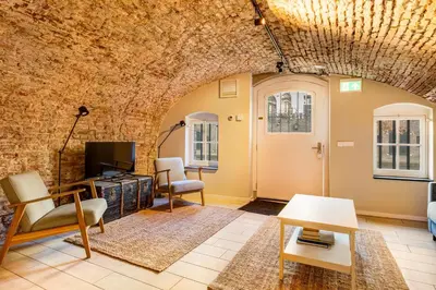 a living room with a brick wall at Luxurious canal apartment in Utrecht A Location in Utrecht