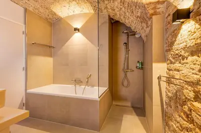 a bathroom with a shower and a bath tub at Luxurious canal apartment in Utrecht A Location in Utrecht