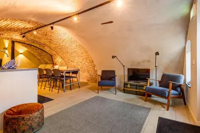 a room with chairs and a table with a tv at 2 Luxurious canal apartments in Utrecht in Utrecht