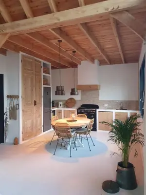 a kitchen and dining room with a table and chairs at Rustic Lake House in Vinkeveen