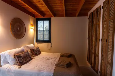 a bedroom with a bed and a window at Rustic Lake House in Vinkeveen