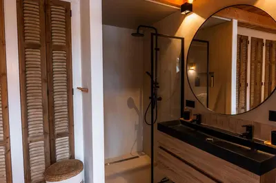 a bathroom with a mirror and a sink and a shower at Rustic Lake House in Vinkeveen