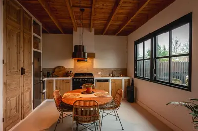 a kitchen with a table and chairs in a room at Rustic Lake House in Vinkeveen