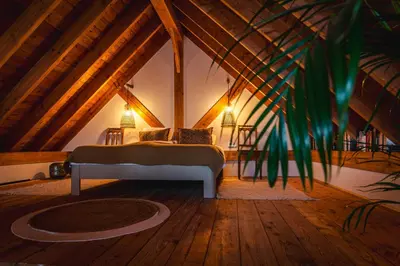 a bedroom with a bed in a attic at Rustic Lake House in Vinkeveen