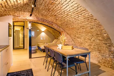 a dining room with a table and a brick wall at 4P Unique canal apartment A Location in Utrecht in Utrecht