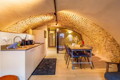 a kitchen and dining room with a brick wall at 4P Unique canal apartment A Location in Utrecht in Utrecht