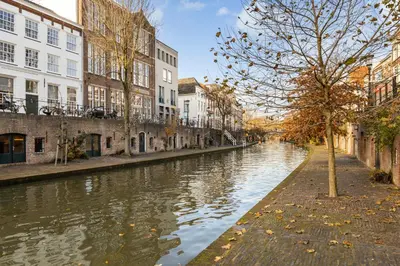a canal in a city with buildings and a tree at 4P Unique canal apartment A Location in Utrecht in Utrecht