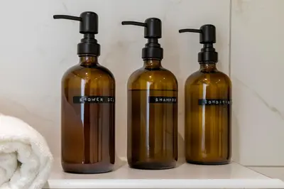 three bottles sitting on a shelf in a bathroom at 4P Unique canal apartment A Location in Utrecht in Utrecht