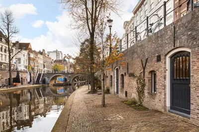 a street in a city with a canal and buildings at 4P Unique canal apartment A Location in Utrecht in Utrecht