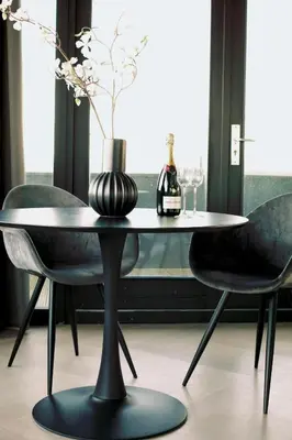 a table with two chairs and a bottle of champagne at Luxe Wellness Suite Zaandam - Amsterdam in Zaandam