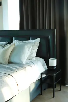 a bed with a black headboard and a side table at Luxe Wellness Suite Zaandam - Amsterdam in Zaandam