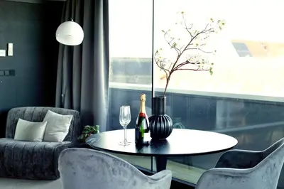 a dining room with a table with two wine bottles at Luxe Wellness Suite Zaandam - Amsterdam in Zaandam