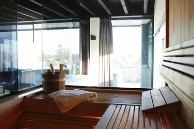 a room with a bench and a large window at Luxe Wellness Suite Zaandam - Amsterdam in Zaandam