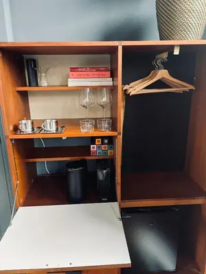 a cupboard with wine glasses and books on it at LeLou in Utrecht