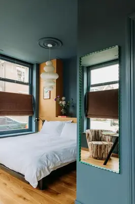 a bedroom with a bed and a mirror at LeLou in Utrecht