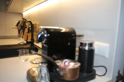 a kitchen counter with a coffee maker and a cup at Cozy Apartment in the Centre of Amsterdam in Amsterdam