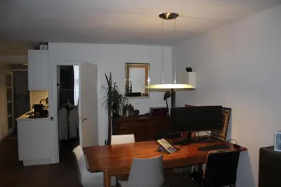 a dining room with a desk with a computer on it at Cozy Apartment in the Centre of Amsterdam in Amsterdam