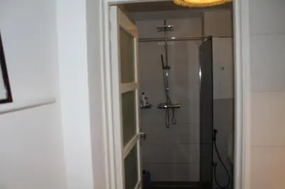 a bathroom with a shower and a mirror at Cozy Apartment in the Centre of Amsterdam in Amsterdam