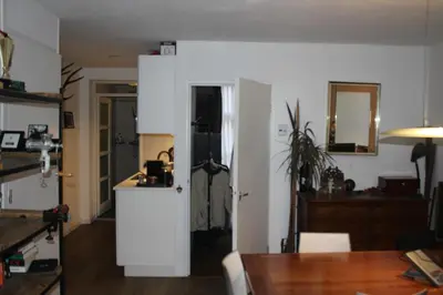 a living room with a kitchen and a dining room at Cozy Apartment in the Centre of Amsterdam in Amsterdam