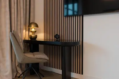 a room with a table and a chair and a lamp at LevelUp Amsterdam in Amsterdam