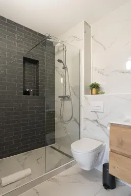 a bathroom with a toilet and a glass shower at LevelUp Amsterdam in Amsterdam