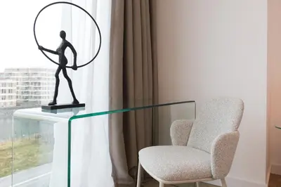 a statue of a man with a mirror next to a chair at LevelUp Amsterdam in Amsterdam