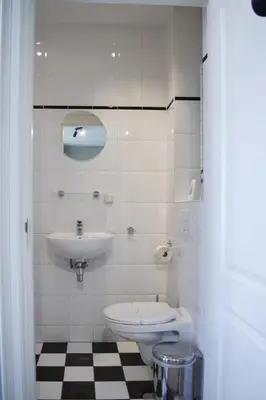 a white bathroom with a sink and a toilet at NEW Roof terrace apartment in Jordaan Area in Amsterdam