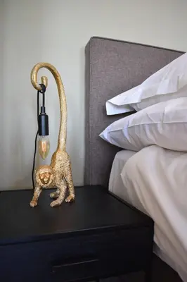 a lamp on a table next to a bed at NEW Roof terrace apartment in Jordaan Area in Amsterdam